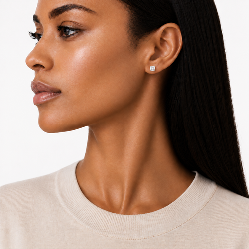 model wears 0.5ct Moissanite Four-Prong Stud Earrings, white gold plated sterling silver