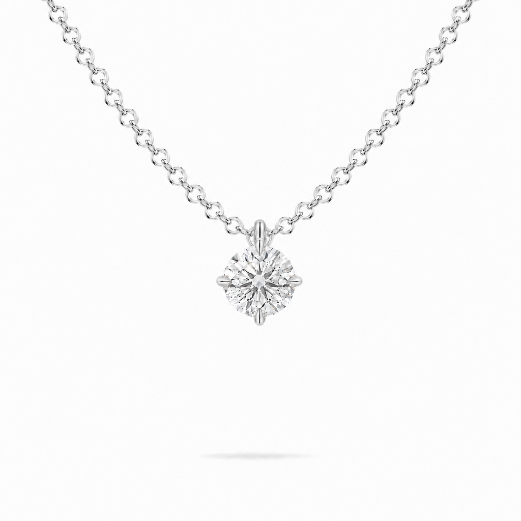 A round brilliant cut moissanite weighing 0.5ct in a classic solitaire necklace, white gold plated sterling silver