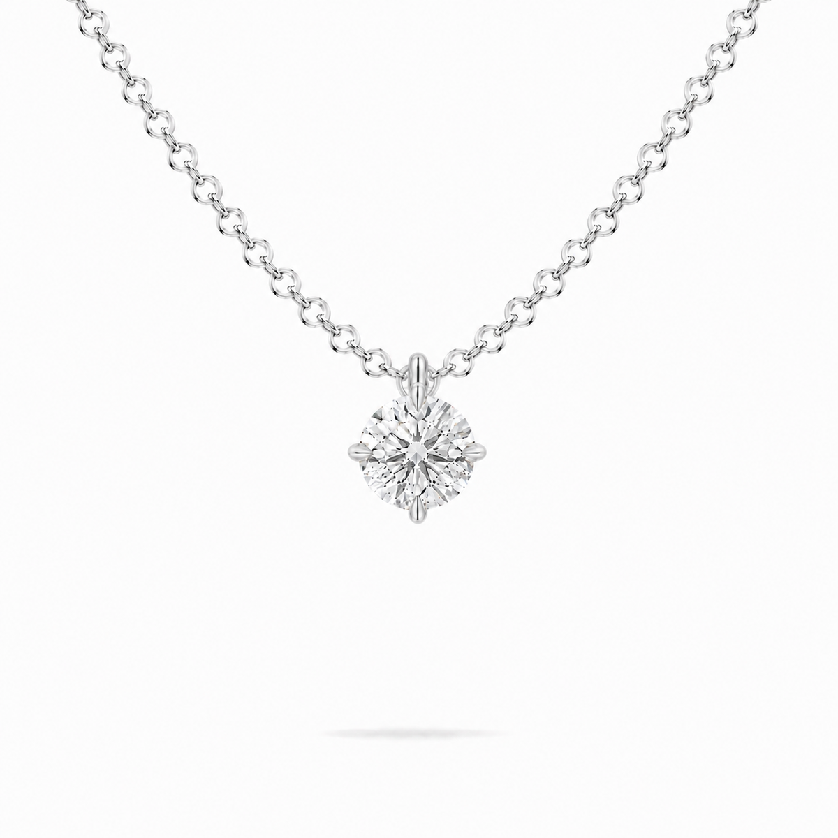 A round brilliant cut moissanite weighing 0.5ct in a classic solitaire necklace, white gold plated sterling silver