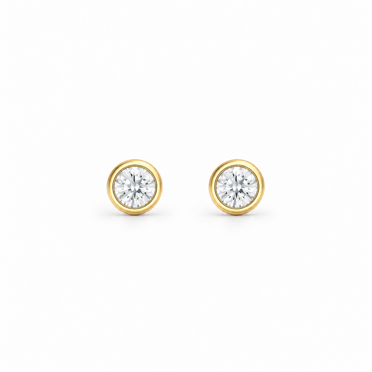 A pair of round-cut moissanite stud earrings in yellow gold bezel settings, by knightley