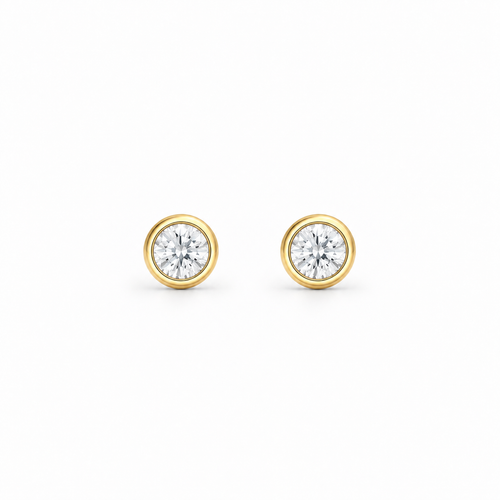 A pair of round-cut moissanite stud earrings in yellow gold bezel settings, by knightley