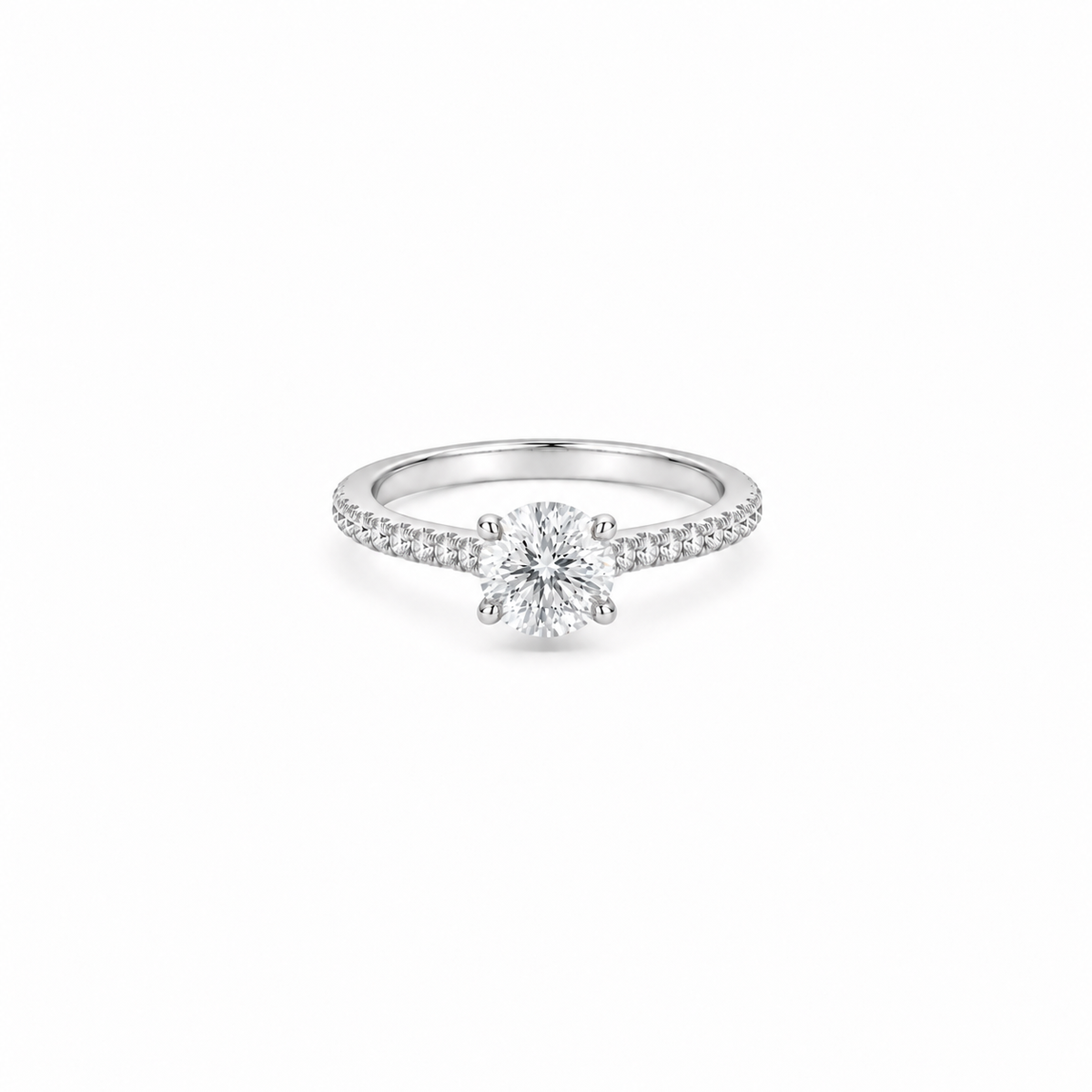 A 1ct round brilliant cut moissanite solitaire ring with a pavé band, white gold plated sterling silver