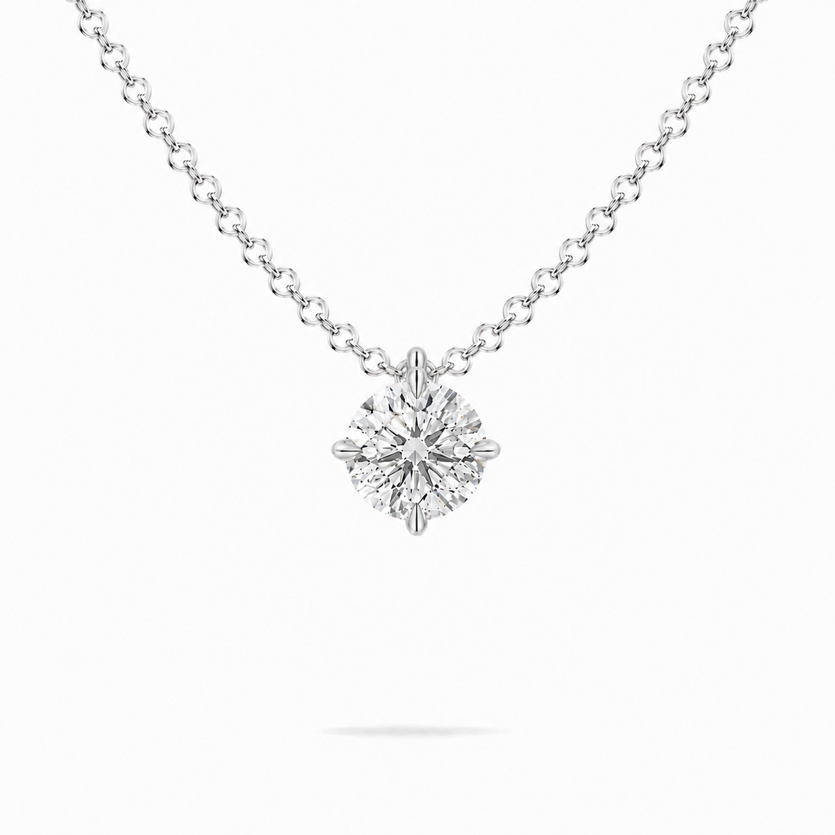 A round brilliant cut moissanite weighing 1ct in a classic solitaire necklace, white gold plated sterling silver