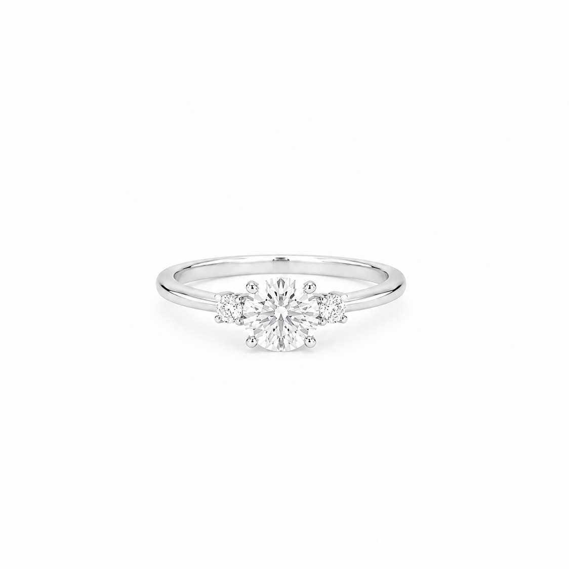 A trio ring with a round brilliant cut moissanite weighing 1ct flanked by two smaller stones, white gold plated sterling silver