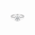 A 2ct round brilliant cut moissanite solitaire ring with a pavé band, white gold plated sterling silver 