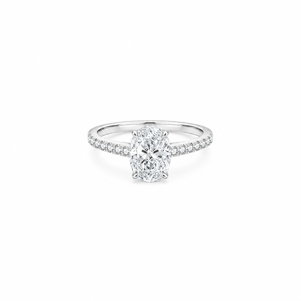 An oval cut moissanite weighing 2ct, accompanied by pavé set stones along the band, white gold plated sterling silver