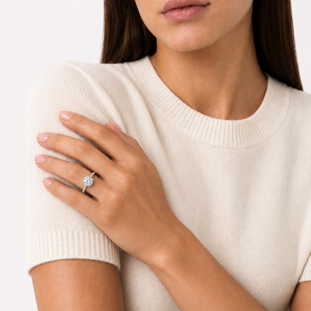 Model wearing 2ct round brilliant cut moissanite solitaire ring, white gold plated sterling silver 