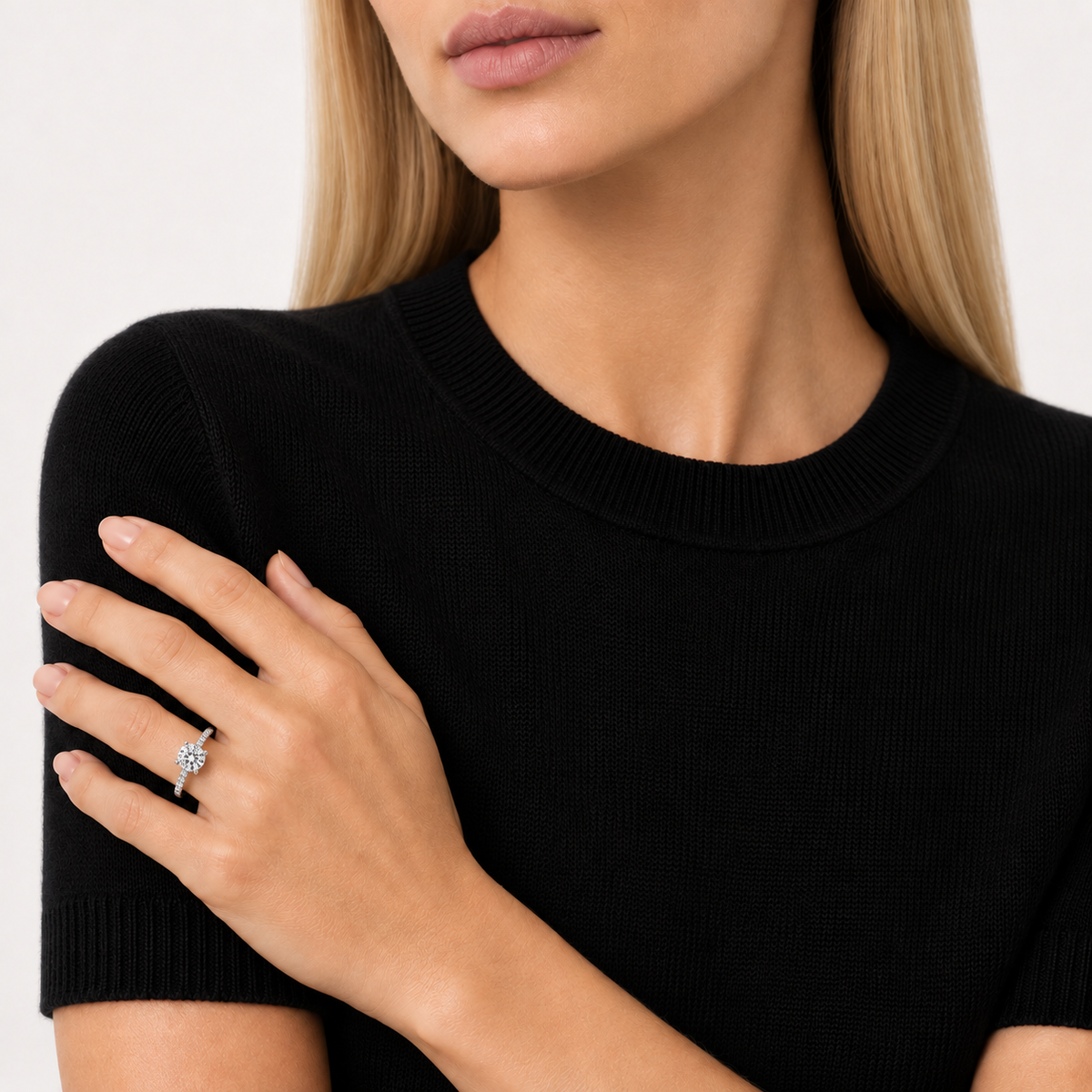 Model wearing 1ct round brilliant cut moissanite solitaire ring, white gold plated sterling silver