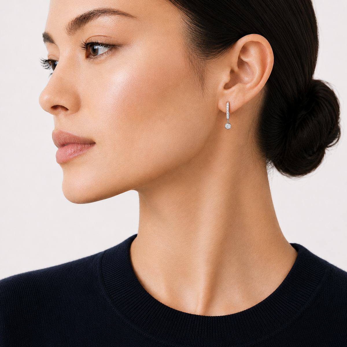 model wearing Moissanite Bezel Drop Huggie Earrings, sterlng silver. 