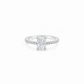 A radiant cut moissanite weighing 1ct, accompanied by pavé set stones along the band, white gold plated sterling silver 
