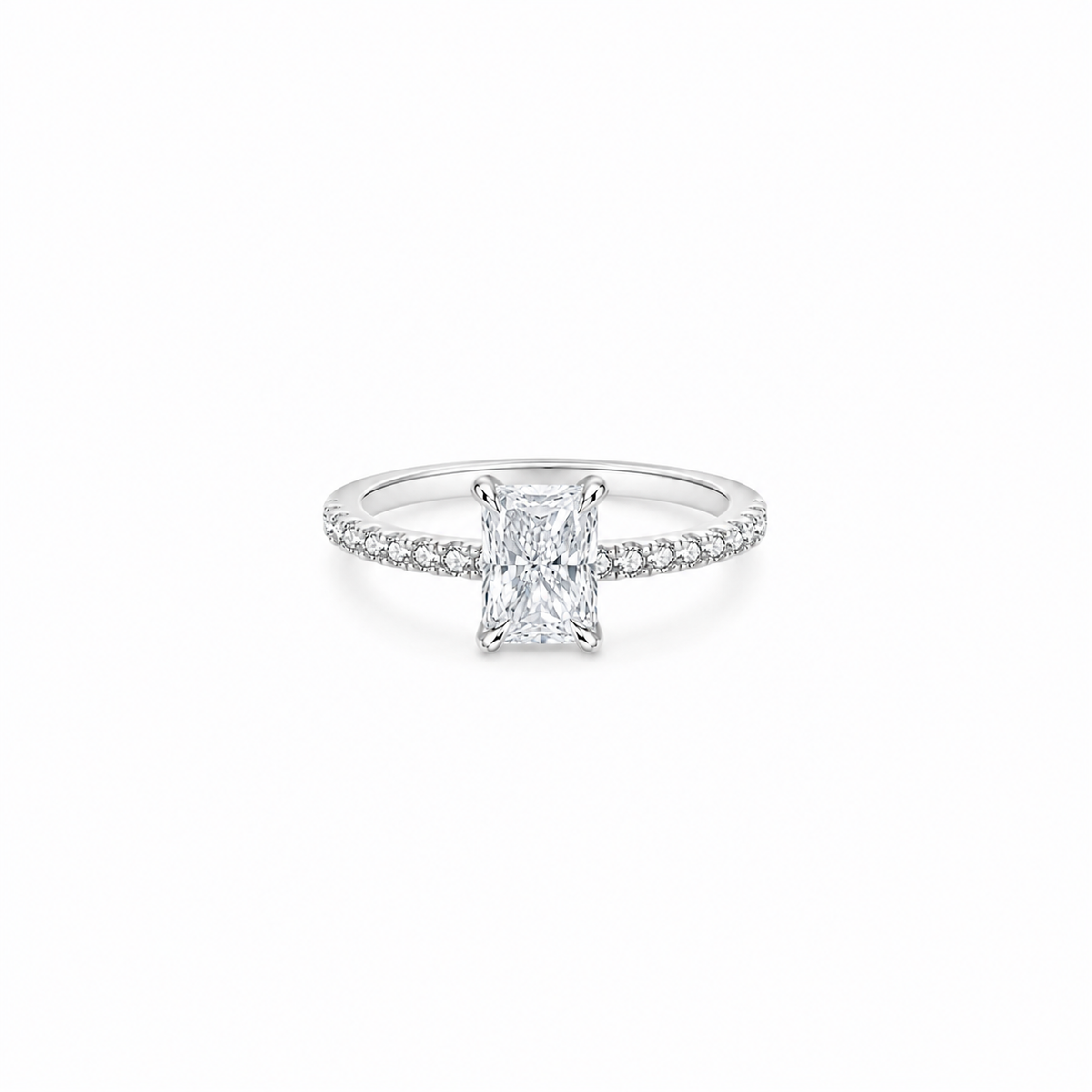 A radiant cut moissanite weighing 1ct, accompanied by pavé set stones along the band, white gold plated sterling silver 